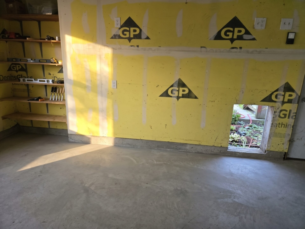 The same room after the debris was hauled away, with a clear floor