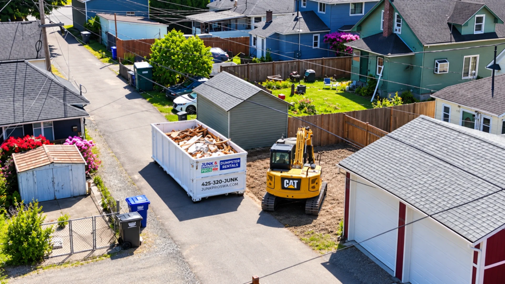 Junk Pros roll-off dumpster in a home driveway, with Mount Rainier and the Seattle skyline behind