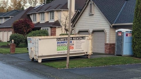 Dumpster In a driveway.