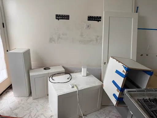 Removed kitchen cabinets and a range waiting for pickup