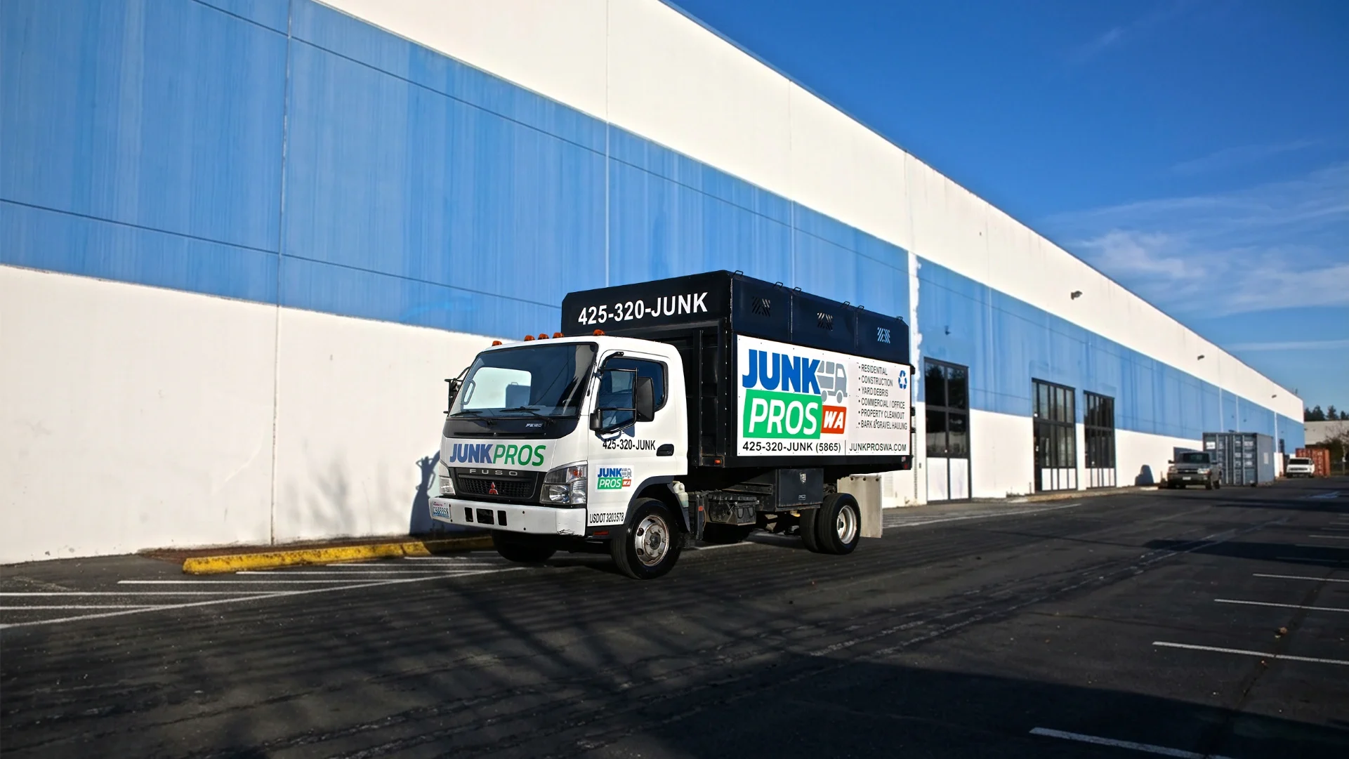 Junk Pros junk removal truck with a high-sided cargo box