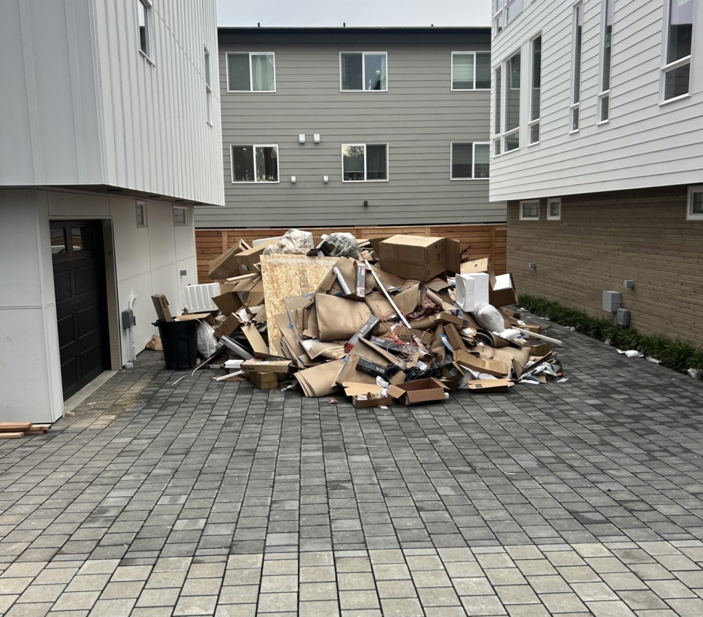 Garage before and after junk removal, with the old furnace and drywall debris hauled away
