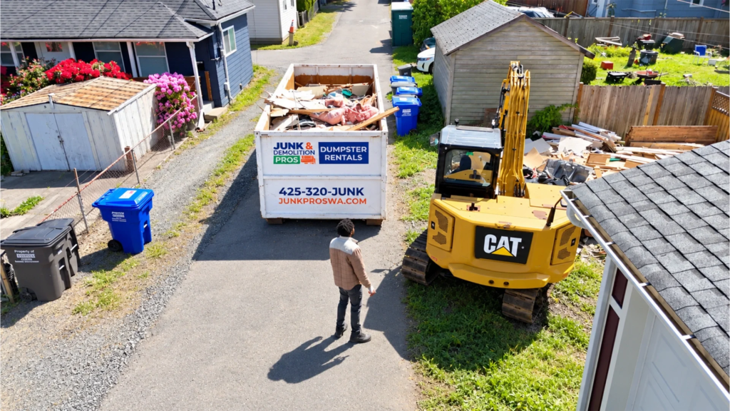 Excavator tearing down a house in a Seattle neighborhood