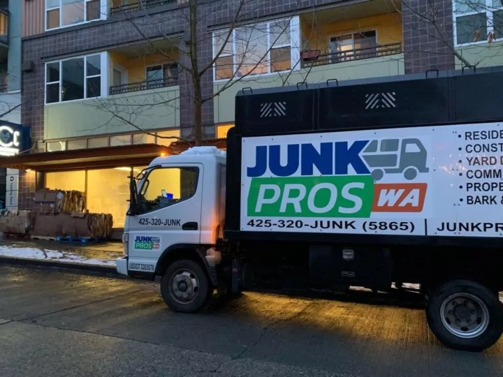 Junk Pros junk removal truck parked outside a Seattle apartment building