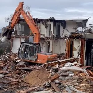 Excavator tearing down a two-story building in Seattle